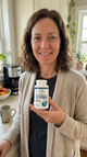 Woman holding Romira Liposomal Glutathione in her kitchen